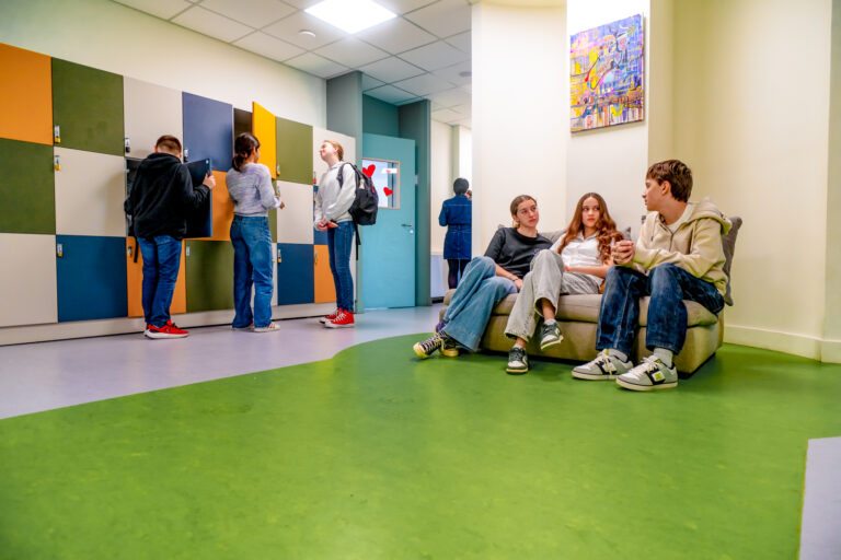 Secondary students talking in the common area at the Alimos campus